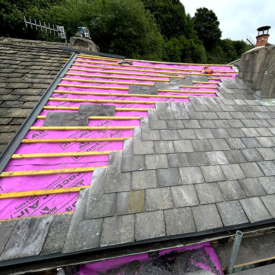 Traditional slate roof under construction